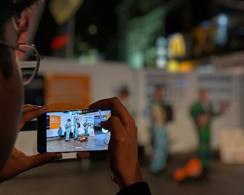 Smartphone displaying a fictional mobile game at an Australian gaming technology exhibition